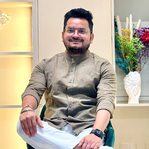 Portrait of Vivek Dubey, owner and digital marketing manager in Dubai, sitting confidently in a contemporary workspace.